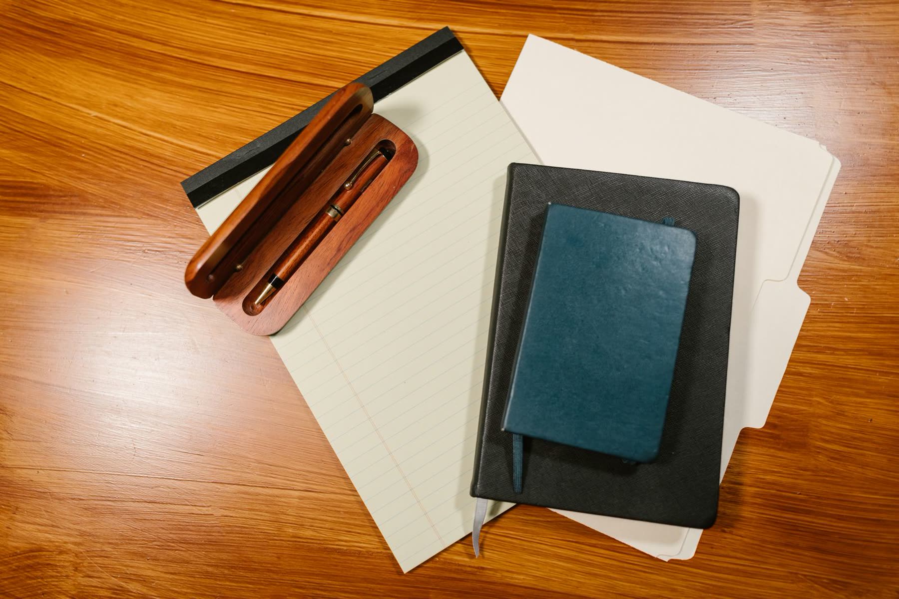 A calm, orderly office desk with papers and a pen