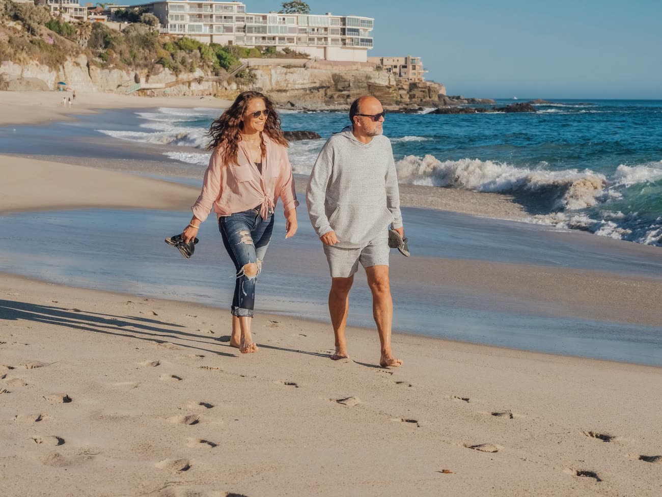 An older couple walking on a beach